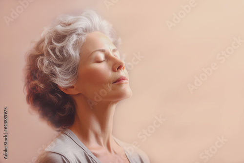 portrait of elderly woman with closed eyes meditation  doing breathing yogic practices on pink background. Close-up. Banner