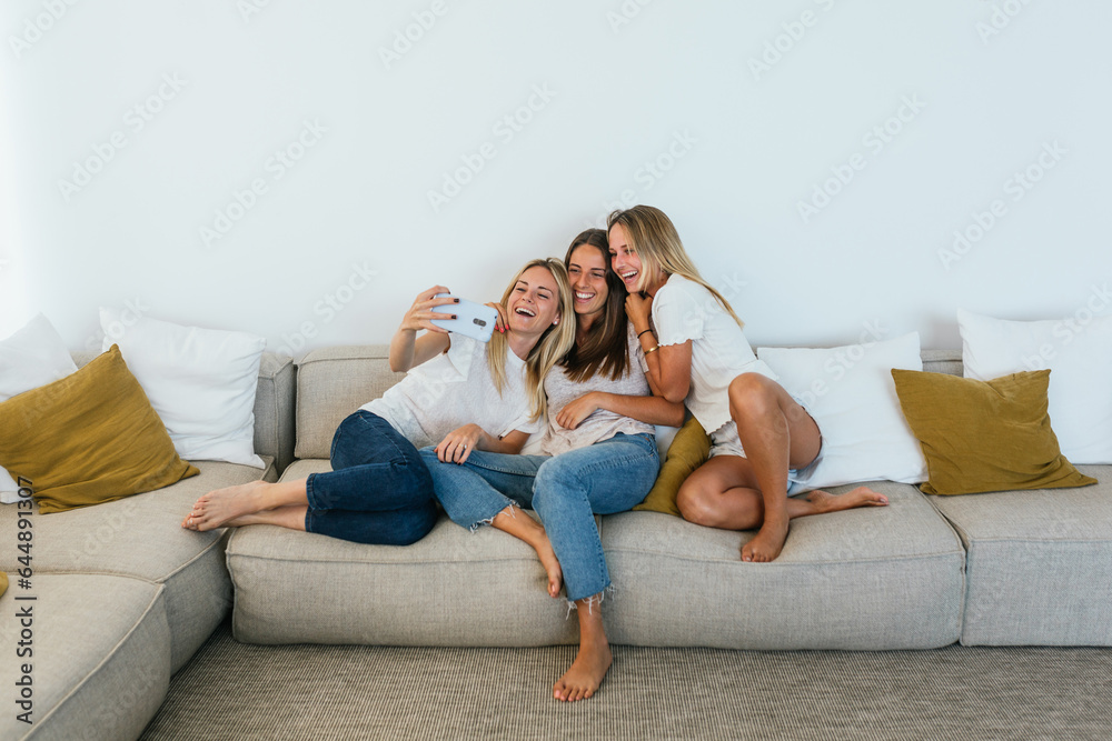 Woman taking a selfie with her sisters Woman taking a selfie with her sisters