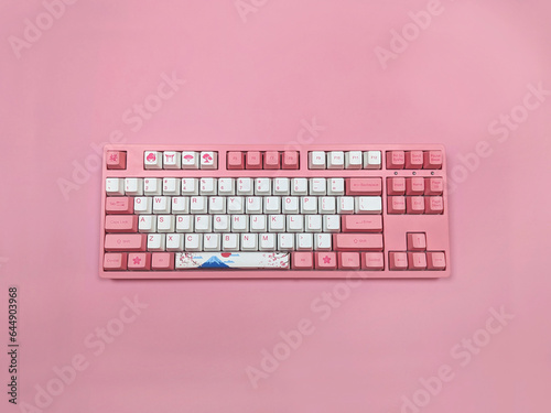 Pink mechanical keyboard on the table on beautiful background