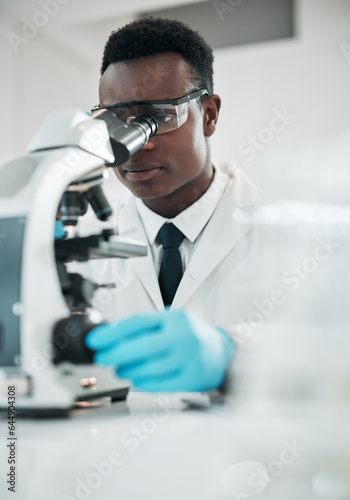 Microscope  black man and analytics with research  medical and experiment for vaccine  test or sample. African person  scientist or researcher with lab equipment  pathology or biotechnology with cure