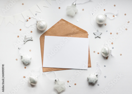 Christmas and New Year template for greeting card with Christmas tree toys and confetti on white background. Mockup with horisontal blank sheet of paper. Template for greeting card 