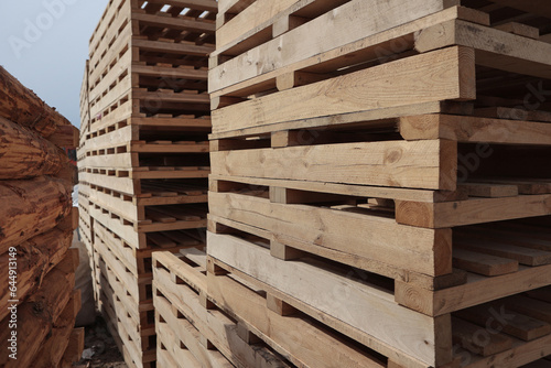 Wooden pallets. Stacking of wooden pallets. Concept of cargo transportation and shipping.Wooden pallets for transportation of building materials.