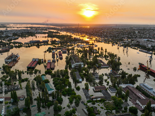 Undermining the dam of the Kakhovka reservoir. Consequences of the dam blowing. Flooded port infrastructure of the city of Kherson. Top view from above, aerial footage. Russian-Ukrainian war photo
