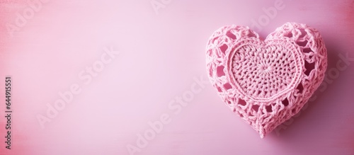 Selectively focused crochet heart against a isolated pastel background Copy space