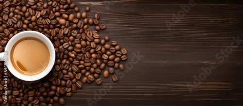The coffee cap on the dark wood table contains coffee beans and paper isolated pastel background Copy space
