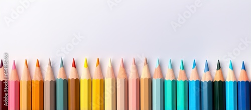 Row of color pencils isolated pastel background Copy space