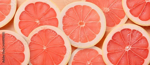 Close up of pomelo and grapefruit sections on a dark wooden cutting board without isolated pastel background Copy space