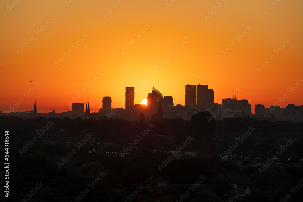 Skyline The Hague with a beautiful red yellow sunrise 