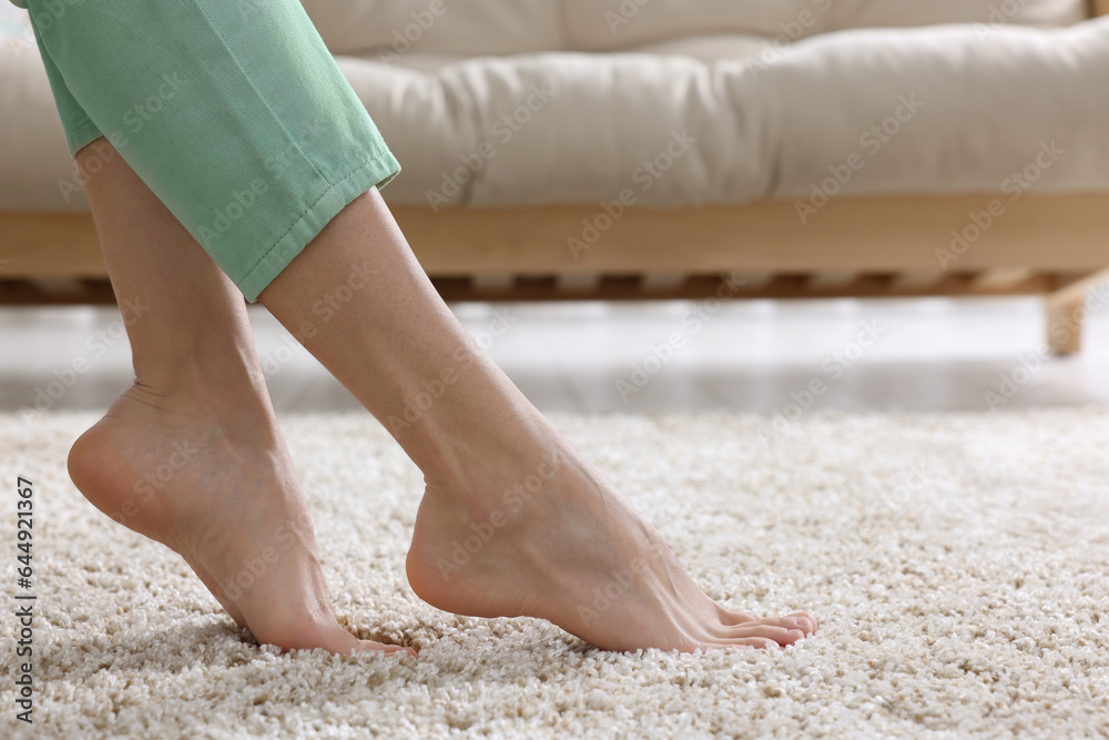 Woman on soft light brown carpet at home, closeup. Space for text