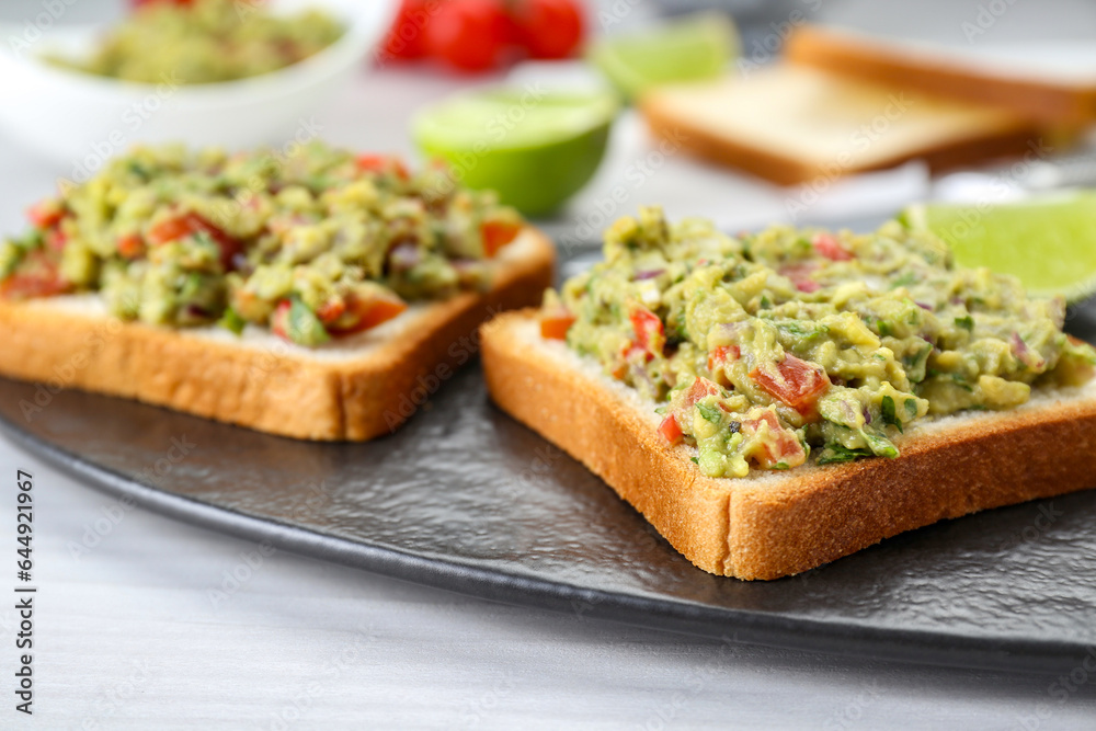 Delicious sandwiches with guacamole on white table, closeup Delicious sandwiches with guacamole on white table, closeup