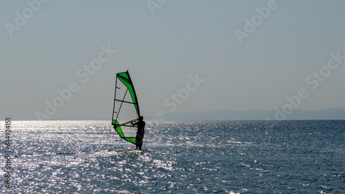 Recreational Water Sports. Windsurfing. Windsurfer Surfing The Wind On Waves In Ocean, Sea. Extreme Sport Action. Summer Fun Adventure.