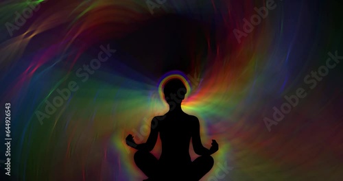 Silhouette of a meditating man against the background of constantly moving multi-colored rays of light. Meditation video. Animated background and club video. Endless cycle. A loop