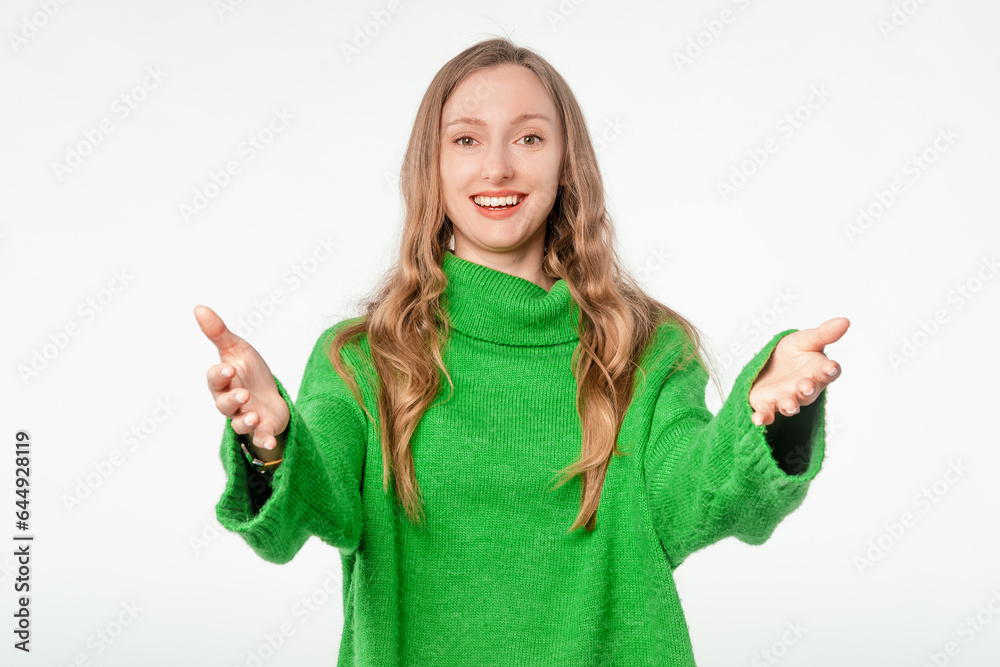 Lovely, friendly woman spreads her arms for hug, cuddle, stands with open hands and smiles happily, white studio background Lovely, friendly woman spreads her arms for hug, cuddle, stands with open hands and smiles happily, white studio background