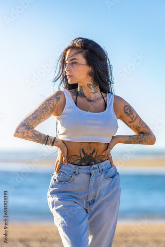 Woman in Jeans and Tank top on the beach photo