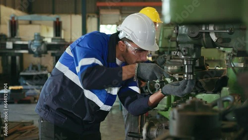 the engineers use machine tools for  the maintenance of the automotive machine at the machining centre factory. 