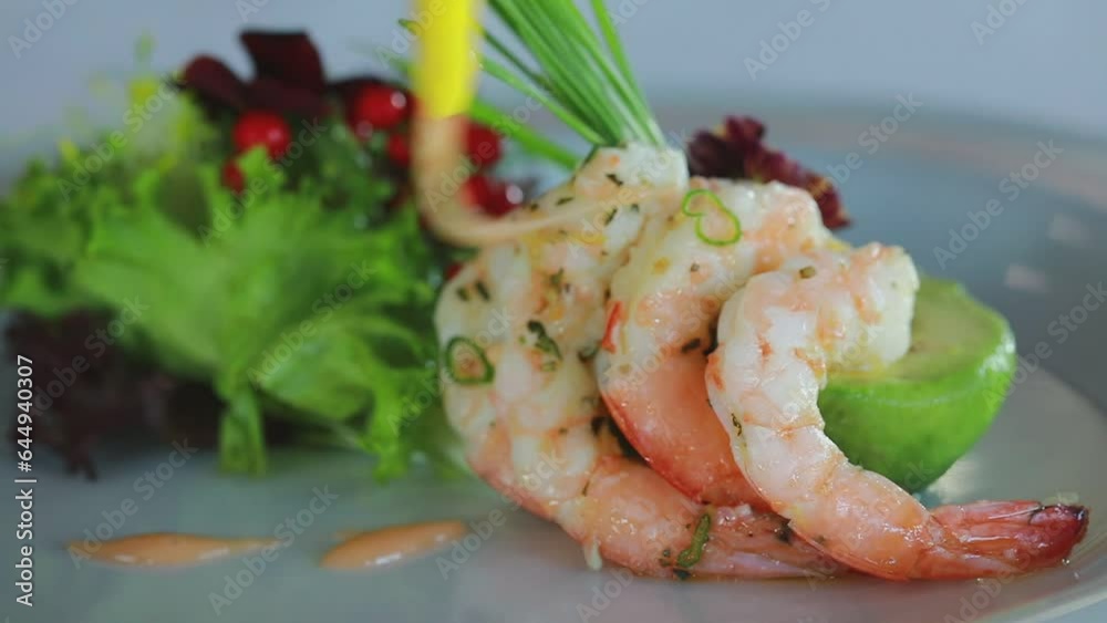 Professional chef pouring sauce over shrimps in a delicious plate for dinner. Professional chef pouring sauce over shrimps in a delicious plate for dinner.