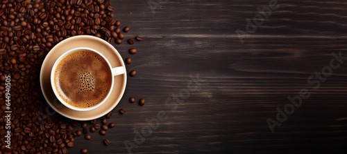 Cup of coffee and coffee beans on wooden background. Copy space, horizontal banner, top view