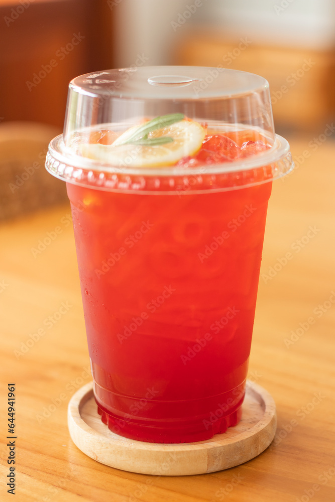 Close-up of tea mixed with lemon and soda in a plastic glass. Close-up of tea mixed with lemon and soda in a plastic glass.