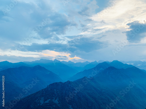 Beautiful alpine landscape with mountain range silhouette. Mountain peaks in the Alps. © Iryna