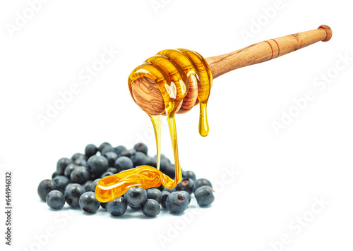 honey dripping on blueberries isolated on white background