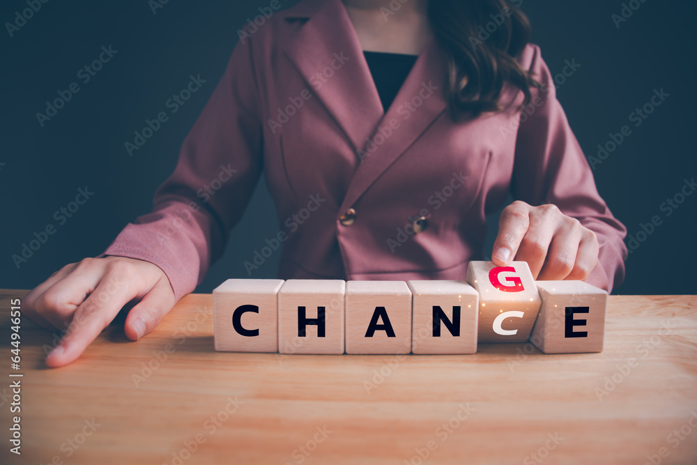 Businesswoman hand flipping wooden blocks with CHANGE to CHANCE text. Economy investment business crisis, technology transformation can make good chance, strategy, solution, positive thinking concept. - obrazy, fototapety, plakaty 