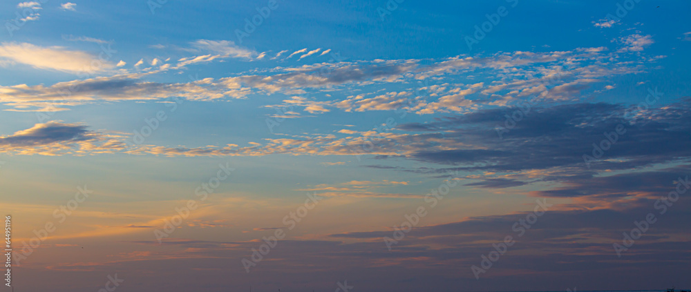 Clouds and sky of morning and evening light,Real amazing panoramic sunrise or sunset sky with gentle colorful clouds. Long panorama, crop it