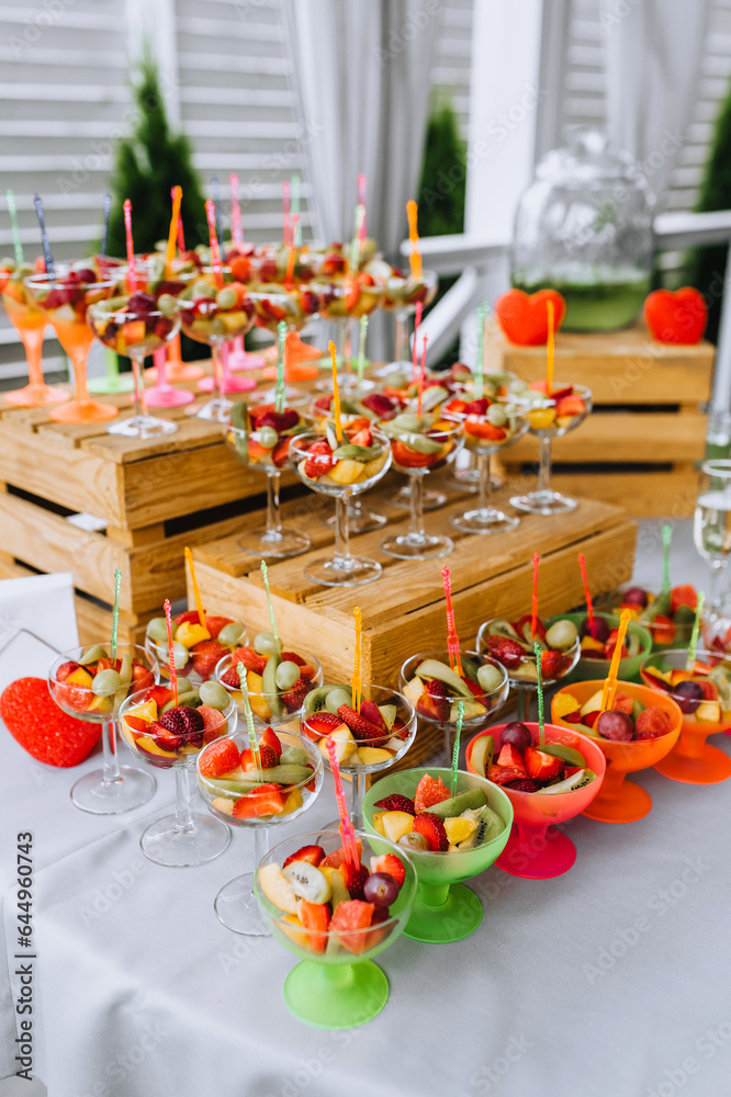 Fresh fruits are on the table, in a bowl at a banquet. Food photography, buffet.