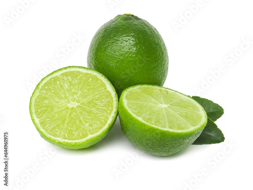 Fresh green lemons and lime leaves placed on a white background.