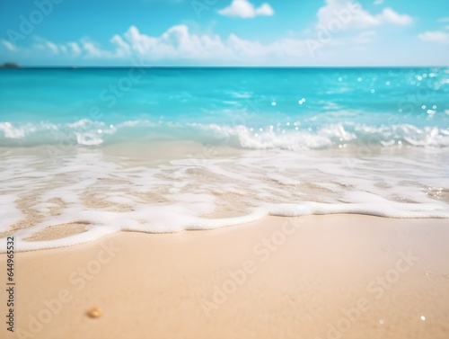 Light sand beach and turquoise ocean water with clear blue sky blurred bokeh background