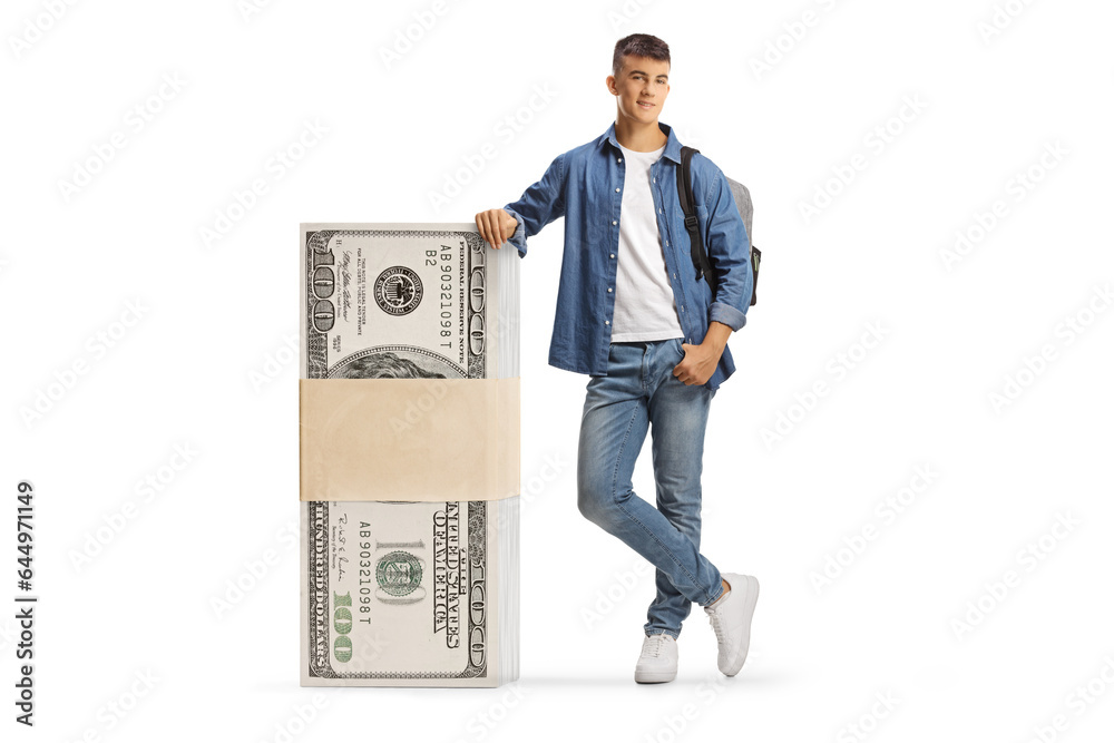 Male student leaning on a stack of us dollar banknotes Male student leaning on a stack of us dollar banknotes