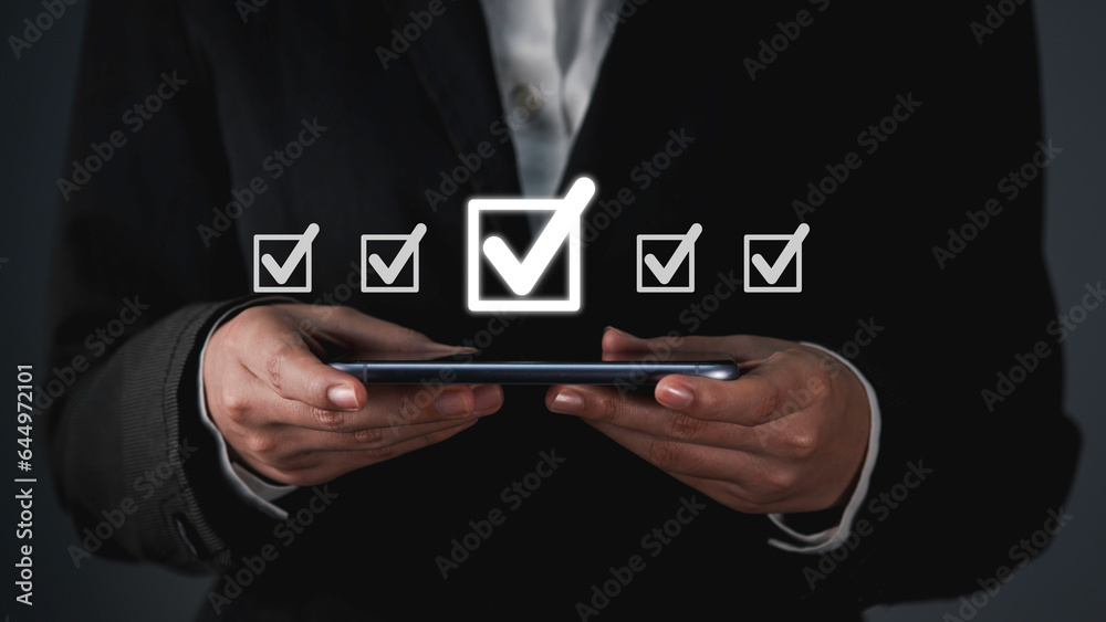 Digital work checklist or electronic smart daily checklist concept. Check mark on virtual screen display for personal working in office Document Management System and process automation.