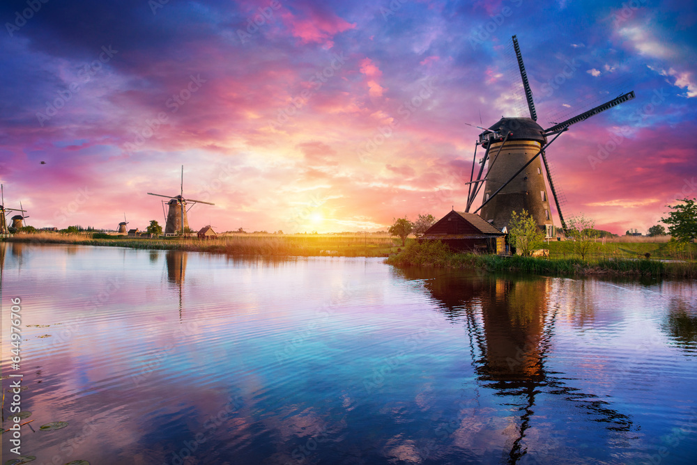 Windmill in Holland Michigan - An authentic wooden windmill from the Netherlands rises behind a field of tulips in Holland Michigan at Springtime. High quality photo