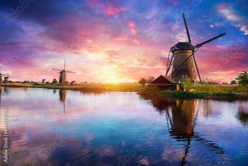 Windmill in Holland Michigan - An authentic wooden windmill from the Netherlands rises behind a field of tulips in Holland Michigan at Springtime. High quality photo