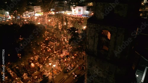 high angle view of a church in a well lit cemetery during day of the dead in Mexico
