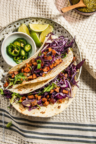 Tacos with roasted chiken with cabbage, salad, feta cheese and sauce