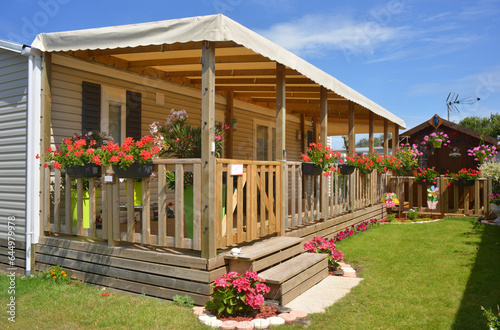 Mobile home with wooden terrace and garden