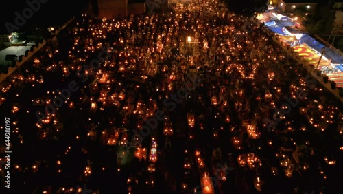 Flying over a well lit cemetery during day of the dead in Mexico