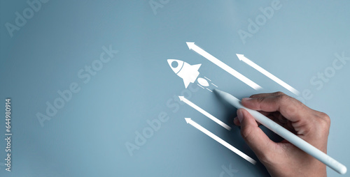 Business start up, start, new project, new idea concept. Magnifying glass focus on rocket launch with arrow  Leadership business strategy for goal target success. photo