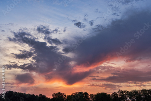 Clouds over treelike at twilight. © David Arment