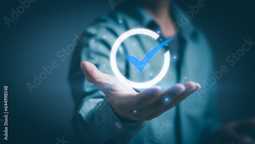 Businessman showing warranty icon on hand ,concept of certification standards, quality control (QC), quality assurance (QA) or customer satisfaction guarantee of corporate business