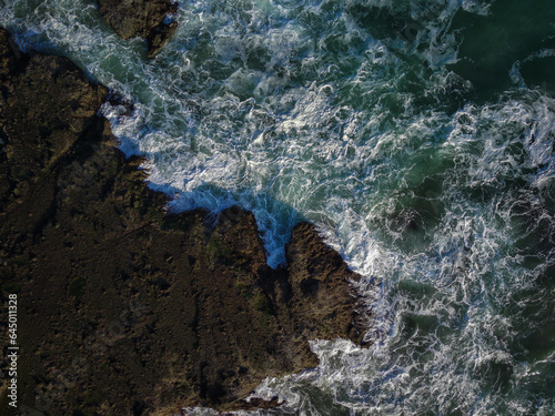 Stunning aerial photo of coastal coral with crashing waves