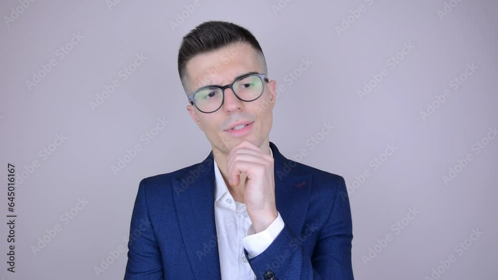 Young thoughtful man. Concept of a pensive businessman or office worker. A thoughtful gesture. Young thoughtful man. Concept of a pensive businessman or office worker. A thoughtful gesture.