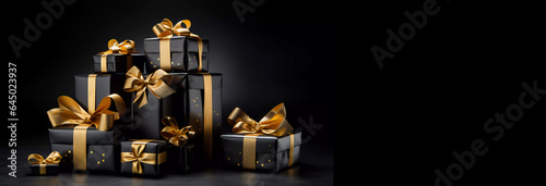 christmas or Black Friday gifts or presents in black and gold on a black background