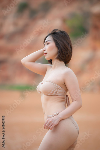 Portrait of young asian beautiful woman wear bikini side river on the daylight,Thailand people,Summer fashion concept,Relax time