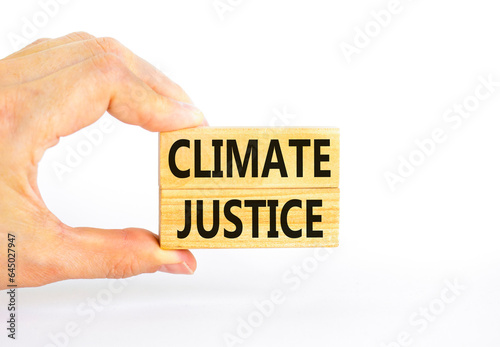 Climate justice symbol. Concept words Climate justice on beautiful wooden blocks. Beautiful white table white background. Businessman hand. Business environment climate justice concept. Copy space.