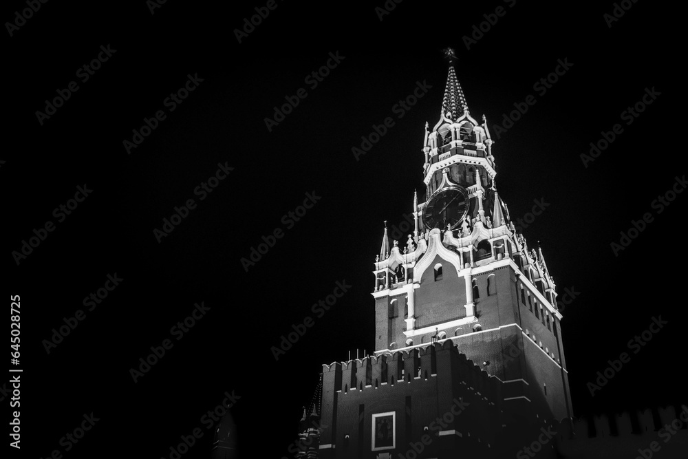 The black and white photo of the Kremlin Clock (Kremlin Chimes)
on the historic the Spasskaya Tower of Moscow Kremlin, Russia.