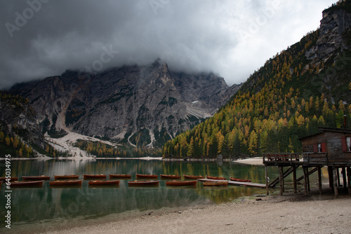 Wooden boats and Lago di Braies in Dolomites, and seekofel dolomite massif in Italy Europe