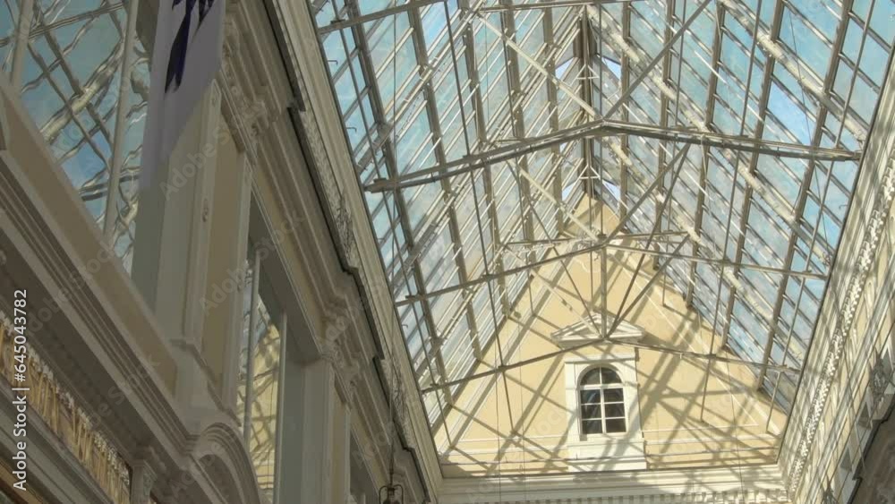 beautiful glass ceiling of old style Europian shopping mall with blue sky through. old Europian building in new-greek style in St, Petersburg beautiful glass ceiling of old style Europian shopping mall with blue sky through. old Europian building in new-greek style in St, Petersburg
