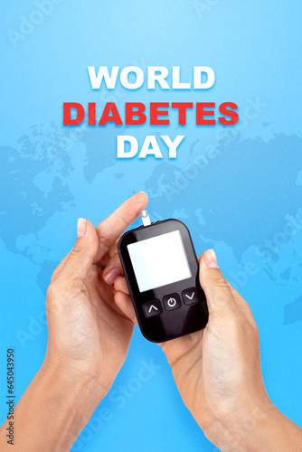World Diabetes Day November 14, there is an electronic test strip for measuring glucose levels in the blood and body in young woman hands, the isolation on a blue background with world map, top view