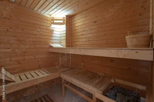 Sauna bath warm interior inside a barrel water bucket in a hotel for spa treatments.
